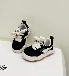 Detailopname van zwarte canvas peutersneakers met stijlvolle witte golvende zolen