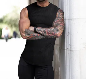 Detail shot of men's black ribbed knit fitness tank top with muscular arm view.