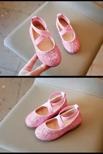 Detailed view of pink glitter girl's princess shoes featuring elastic cross straps