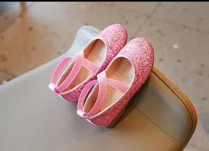 Detail view of pink glitter girl's princess shoes featuring cross elastic straps