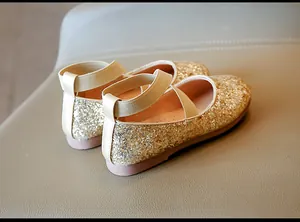Detailed view of gold sequin girls' princess flats with comfortable elastic cross straps