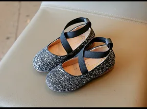 Detail view of girls sparkly silver glitter Mary Jane shoes with black cross straps