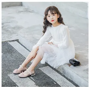 Close-up of fashionable pink sequin princess shoes with bow and pearl strap details for girls