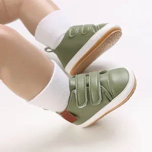 Close-up detail of olive green baby walking shoes with white anti-slip rubber soles