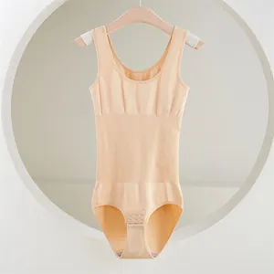 Detailed view of the seamless beige shapewear bodysuit hanging on a classic wooden hanger