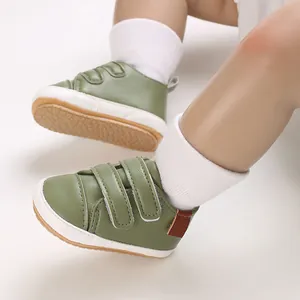 Close-up of olive green infant PU leather walking shoes with velcro straps
