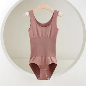 Rose pink seamless shapewear bodysuit with tummy control hanging on a wooden hanger.