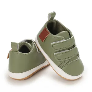 Detail view of olive green PU leather baby walker shoes with double velcro straps