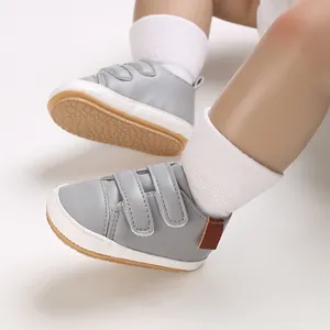 Detailed view of grey baby PU leather sneakers with velcro straps and non-slip soft sole