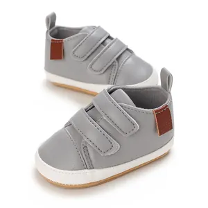 Grey PU leather baby walker shoes with dual velcro straps and brown accents