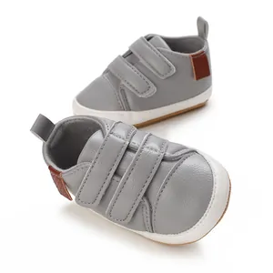 Detailed view of grey PU baby sneakers with anti-slip rubber soles for boys
