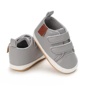 Close-up of gray baby PU sneakers with three velcro straps and anti-slip rubber sole