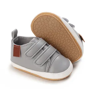 Close-up detail of grey PU leather infant walking shoes with non-slip rubber sole