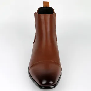 Front view detail of a classic brown leather Chelsea boot with a dark burnished toe