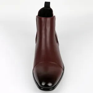 Detailed front view of premium vintage burgundy Chelsea boots featuring a black toe cap design