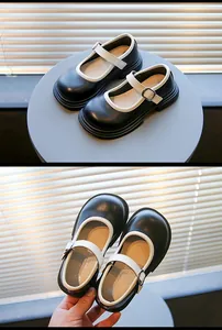 Detailaufnahme von schwarz-weißen Mary Jane-Schuhen für Mädchen mit verstellbarem Riemen