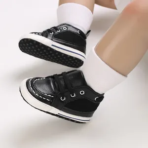Close-up detail of soft sole baby sneakers with lace-up design for infants learning to walk.