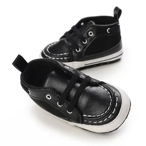 Detailed view of black infant soft-sole walking shoes with white stitching design.