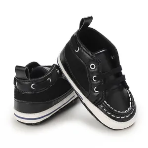 Close-up of black baby pre-walker shoes with white stitching and lace-up design