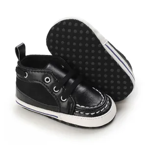 Detail view of black baby pre-walker shoes with soft anti-slip rubber dot sole