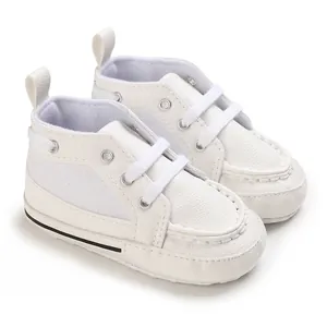 Close-up of white soft-soled baby pre-walker shoes with lace-up detail