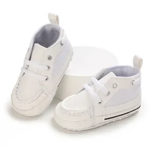 Detailed view of white soft-sole baby walking shoes with elastic laces and heel pull tab.