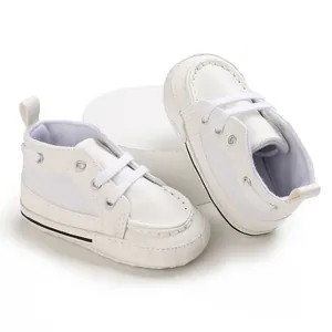 Soft sole white baby walking shoes for 0-1 year olds with classic lace-up detail
