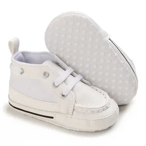 Detail view of white soft-sole baby pre-walker shoes showing anti-slip dot texture