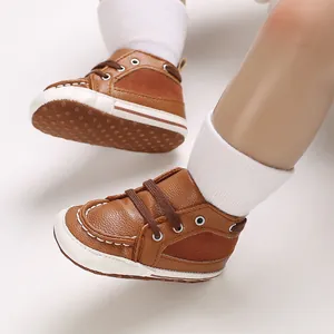 Close-up view of brown leather soft sole baby walking shoes with anti-slip white bottom