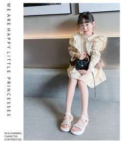 Detail showing fashionable white glittery Roman sandals on a child model for summer