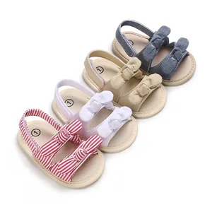 Four pairs of baby sandals in red stripes, white, beige, and denim blue with bow details