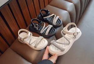 Stylish girls' Roman sandals with glittery rhinestone straps for summer vacation wear.