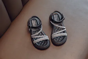 Elegant black girls' Roman sandals featuring sparkling rhinestone straps and soft sole