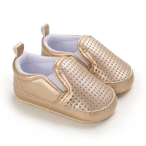 Detailed view of golden PU leather infant pre-walker shoes with breathable hollow design
