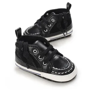 Close-up of black PU baby walking shoes with soft soles and white stitching detail.