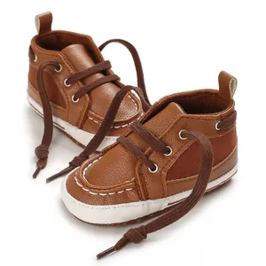 Close-up of brown PU leather baby walking shoes with soft soles and white stitching.