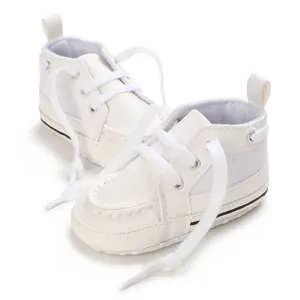 Detailed view of white infant walking shoes with soft PU leather and breathable mesh.