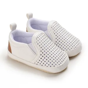 Detailed view of white PU leather infant walking shoes with breathable perforated design