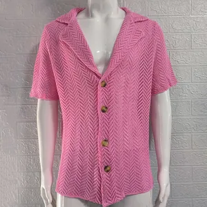 Detail of men's pink hollow knit shirt showing textured herringbone pattern and buttons