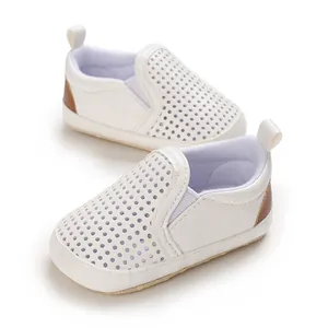 Breathable white baby pre-walker shoes with perforated design and brown heel detail