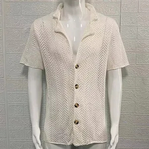 Detailed view of white men's hollow pointelle knit shirt featuring lapel and button closure.