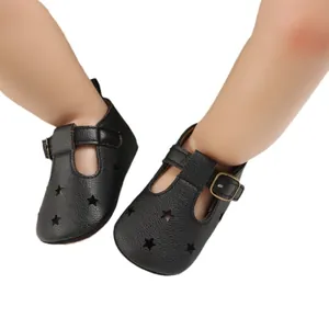 Black soft PU leather baby pre-walker shoes featuring star cutouts and T-strap buckle.