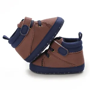 Detailed side view of brown and navy blue high-top soft sole infant walking shoes