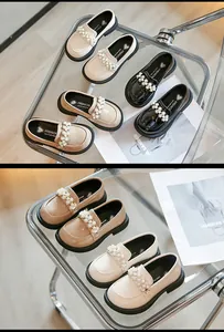 Detailed view of elegant girls' leather princess loafers with decorative pearl straps