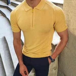 A detailed view of a yellow men's slim fit knit polo shirt featuring a quarter zipper