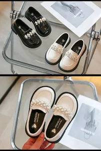 Detailed macro view showing the pearl embellishments and heart insole of these girls' loafers.