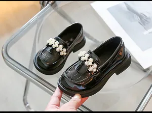 Glossy black patent leather girls' loafers with pearl floral strap and crocodile texture