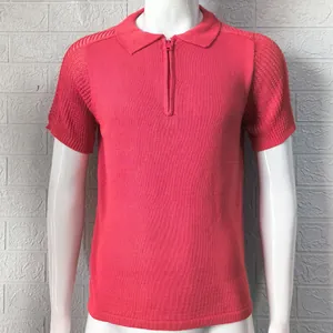 Detailed view of a pink slim-fit knitted polo shirt with a stylish and modern half-zip.