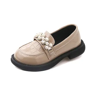 Close-up of girls' pearl princess shoe with glossy finish and crocodile pattern