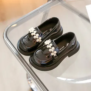 Elegant black patent leather girls' princess loafers with delicate pearl floral accents